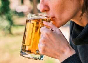 Woman drinks beer