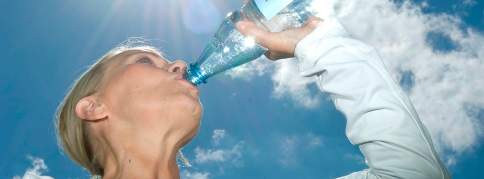 A woman drinks mineral water