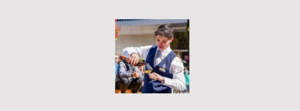 Young man filling beer into a glass